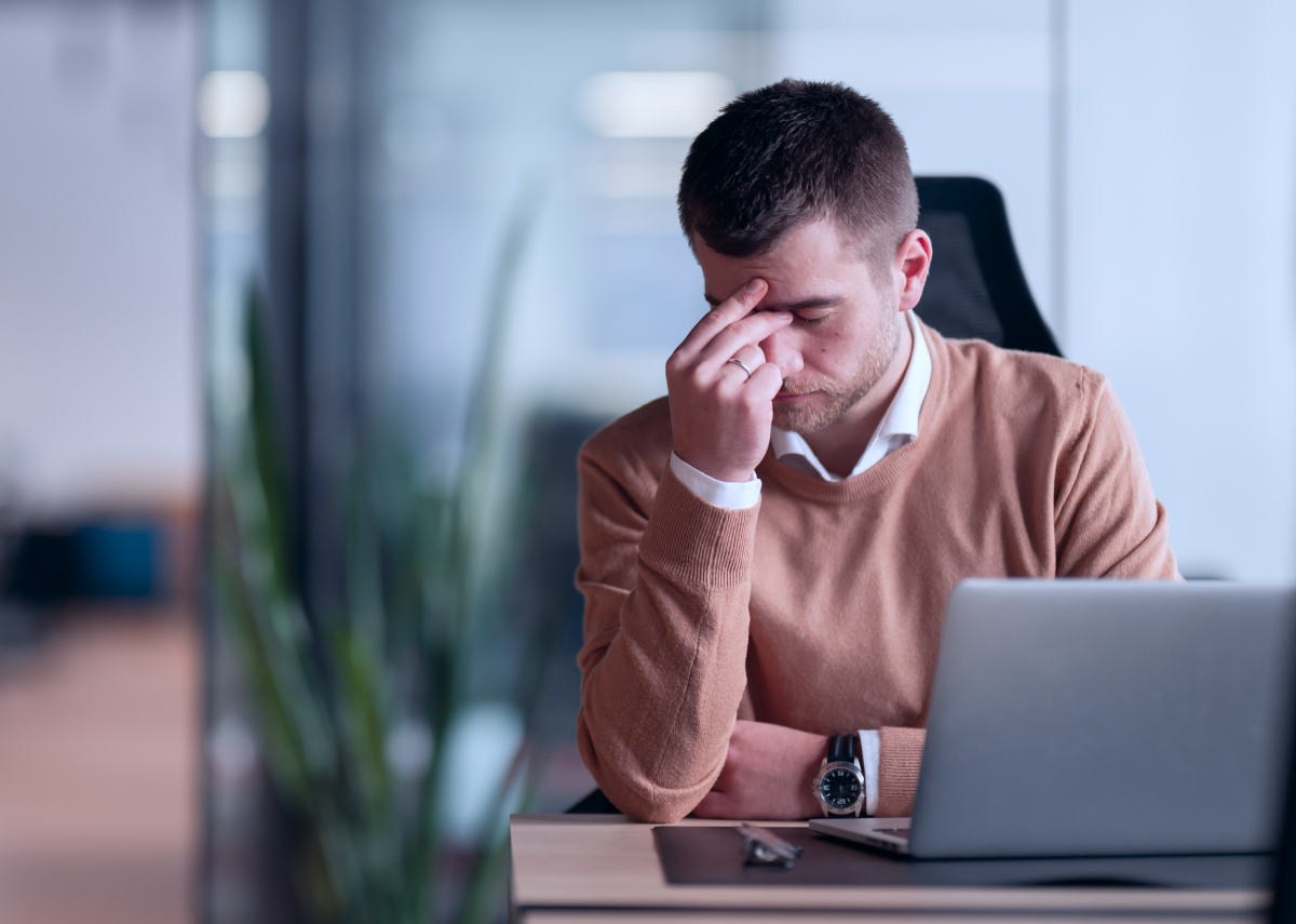 Man looking frustrated in front of computer