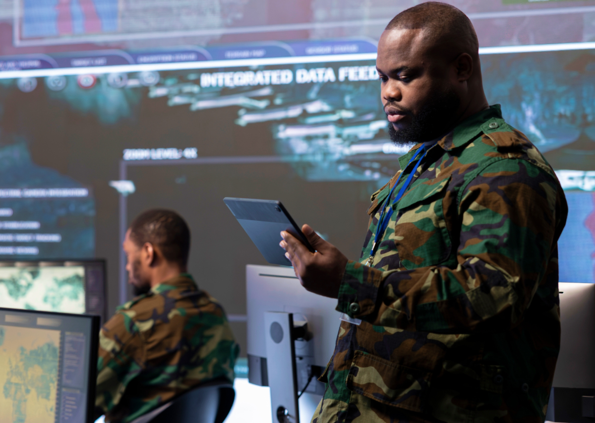 Military personnel looking at tablet