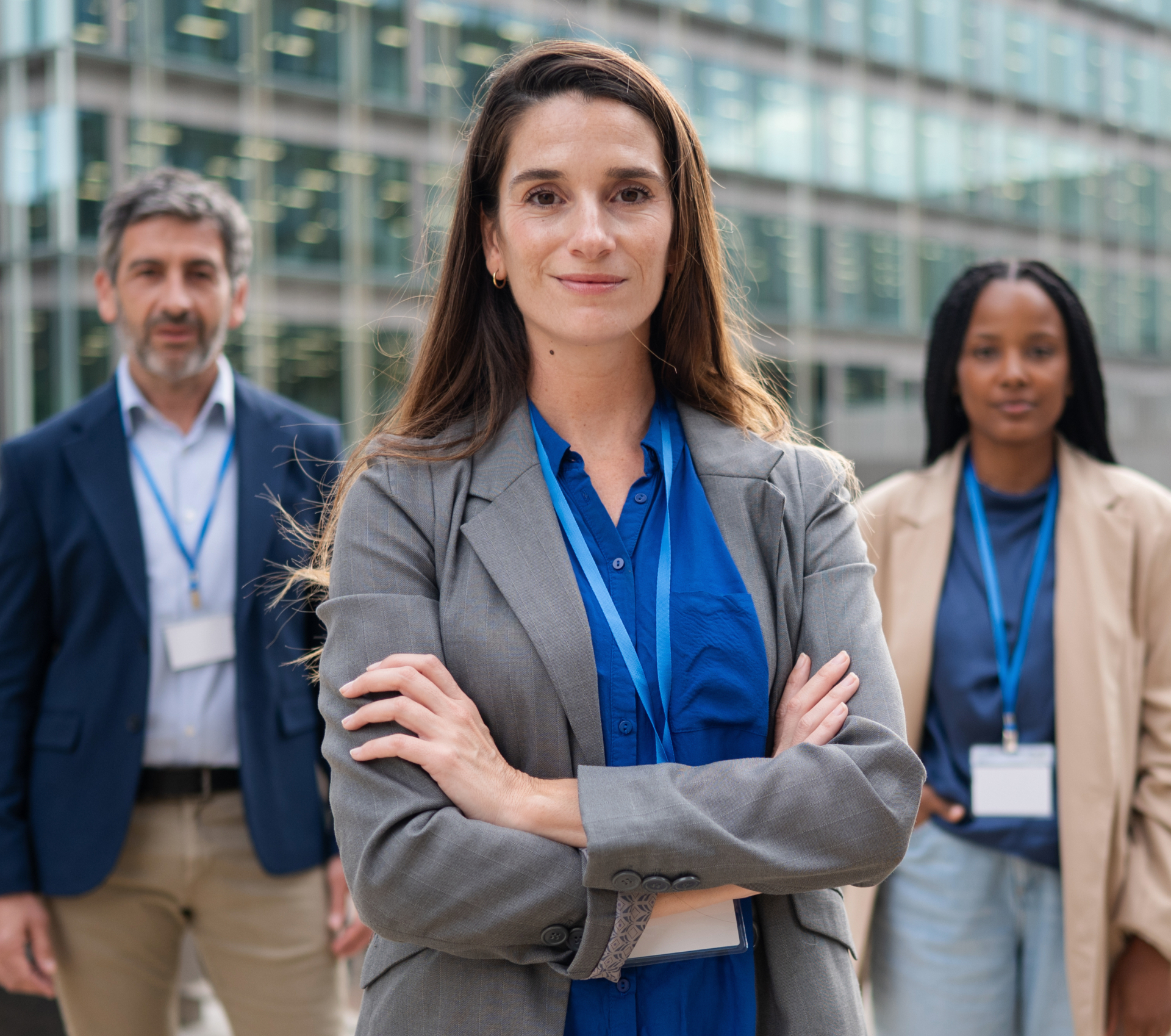 Smiling businesswoman with an ID badge leading a work team